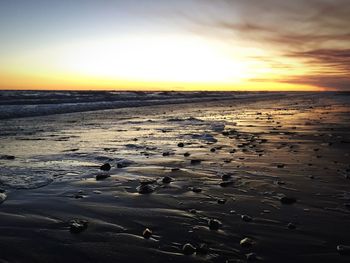 Scenic view of beach against sky during sunset