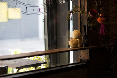 Close-up of stuffed toy hanging on window