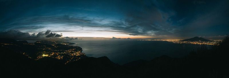 Panoramic view of amalfi coast against cloudy sky at dusk