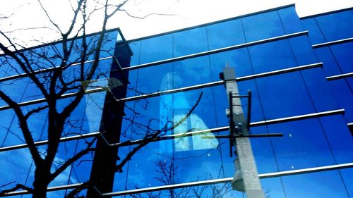 Low angle view of power lines against blue sky