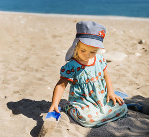 Full length of boy with toy on sand at beach