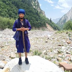 Full length of man standing on rock