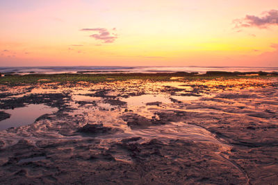 Scenic view of sea against romantic sky at sunset