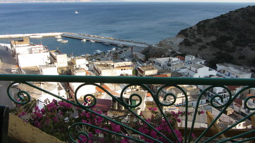 High angle view of town by sea against sky