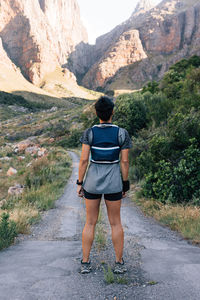 Rear view of woman walking on mountain