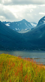 Scenic view of lake and mountains against sky