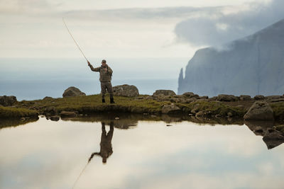 Man fishing in lake