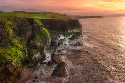 Beautiful white limestone cliffs seen from magheracross viewpoint, dramatic sunset, northern ireland