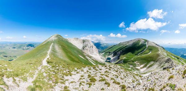 Panoramic view of mountains against blue sky