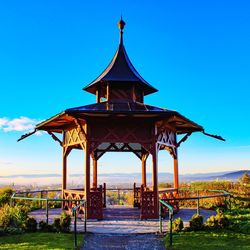 Gazebo by building against clear blue sky