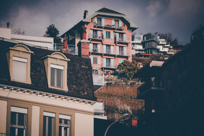 Low angle view of buildings in town against sky