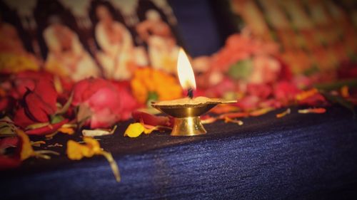 Close-up of lit candles in temple