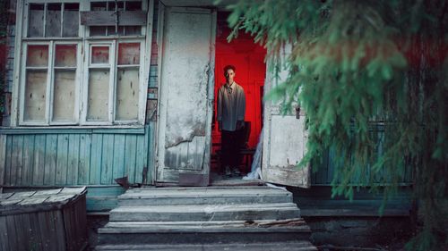 Man standing at entrance of building