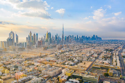 View of cityscape against cloudy sky