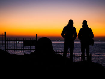 Silhouette couple at beach during sunset