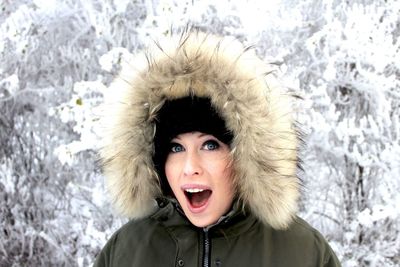 Portrait of woman wearing warm clothing screaming during winter