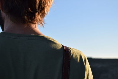 Rear view of man against clear sky