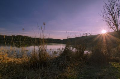 Scenic view of lake at sunset