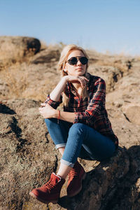 Young woman sitting on rock