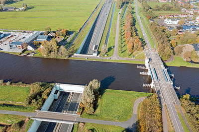 High angle view of vehicles on road along trees