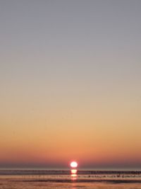 Scenic view of sea against clear sky during sunset