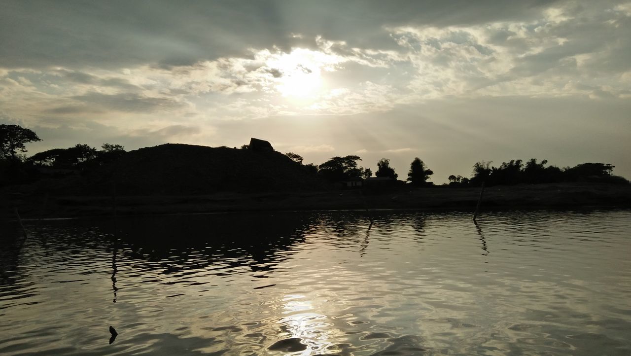 reflection, water, nature, sunset, sky, tree, outdoors, scenics, sunlight, tranquility, beauty in nature, tranquil scene, cloud - sky, silhouette, growth, lake, sun, no people, landscape, day