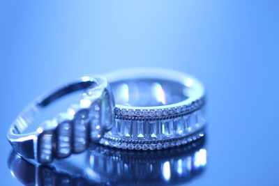 Close-up of wedding rings on blue background