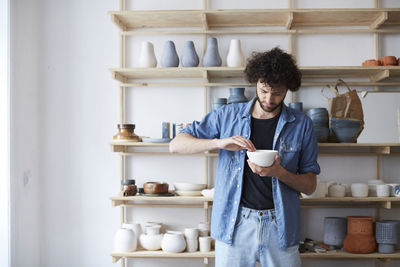 Man learning pottery in art studio