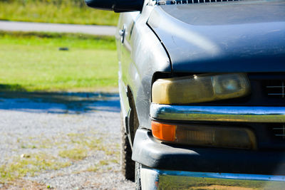 Close-up of car on road