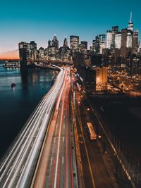 High angle view of light trails on highway by east river in city