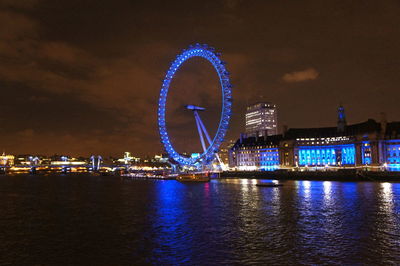 Illuminated ferris wheel at night