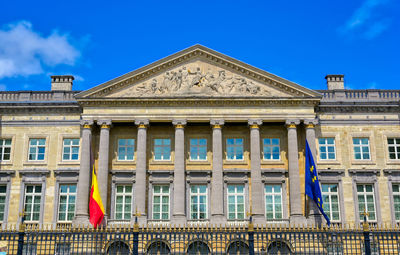 Low angle view of historical building against blue sky