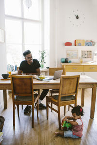 Man sitting on table at home