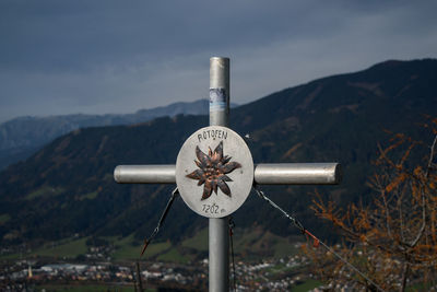 Information sign on landscape against sky