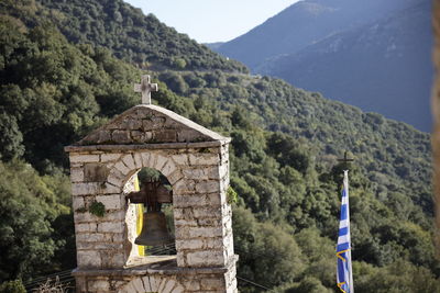 View of bell tower and mountain against sky