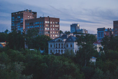 Buildings in city against sky at dusk