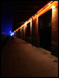 Illuminated tunnel at night