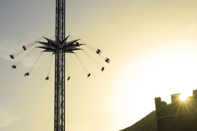 Low angle view of amusement park ride against sky