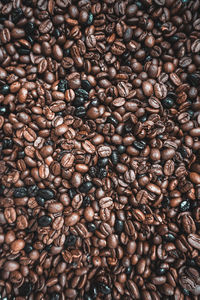 Roasted coffee beans, brown background