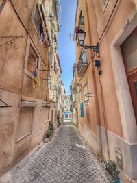 Narrow alley amidst buildings in city