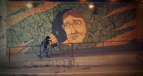 Portrait of man with graffiti on wall