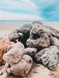 Rocks on beach against sky