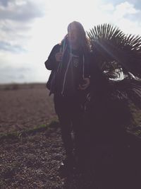 Woman with horse in background