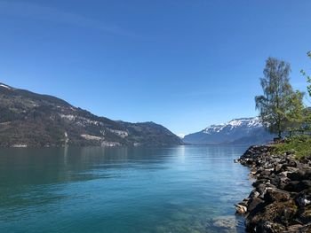 Scenic view of mountains against clear blue sky