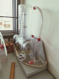 Close-up of electric lamp on wall at home