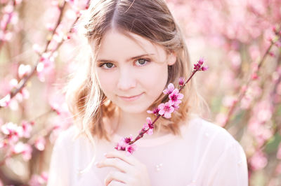Portrait of girl holding twig at park