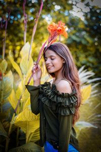 Young girl looking away while standing outdoors