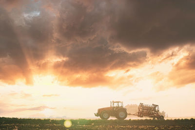 Scenic view of field against sky during sunset