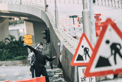 Side view of man standing on city street