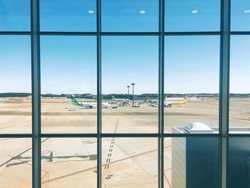 View of airport runway seen through window